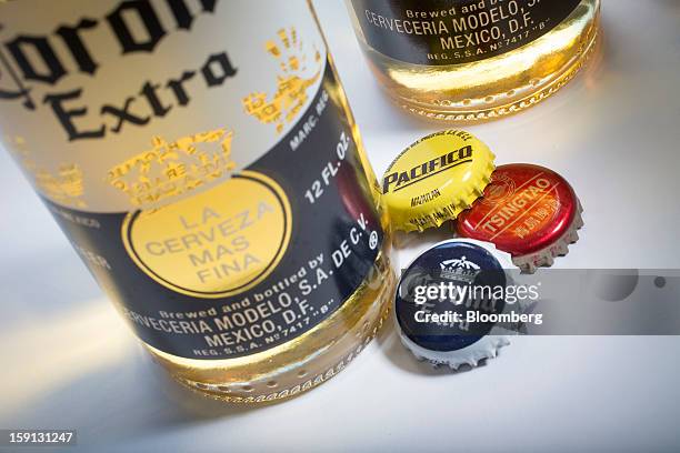 Constellation Brands Inc. Corona Extra, Tsingtao and Pacifico beer caps are arranged for a photograph in New York, U.S., on Tuesday, Jan. 8, 2013....
