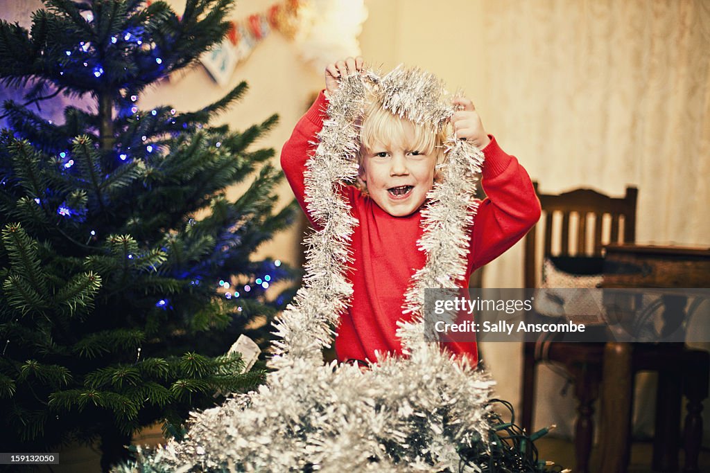 Happy child decorating the Christmas tree