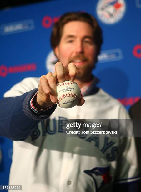 Dickey of the Toronto Blue Jays shows his knuckleball grip as he is introduced at a press conference at Rogers Centre on January 8, 2013 in Toronto,...