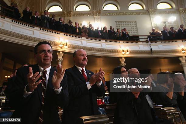 New Jersey lawmakers applaud as New Jersey Governor Chris Christie makes his State of the State Address in the Assembly Chamber at the Statehouse on...