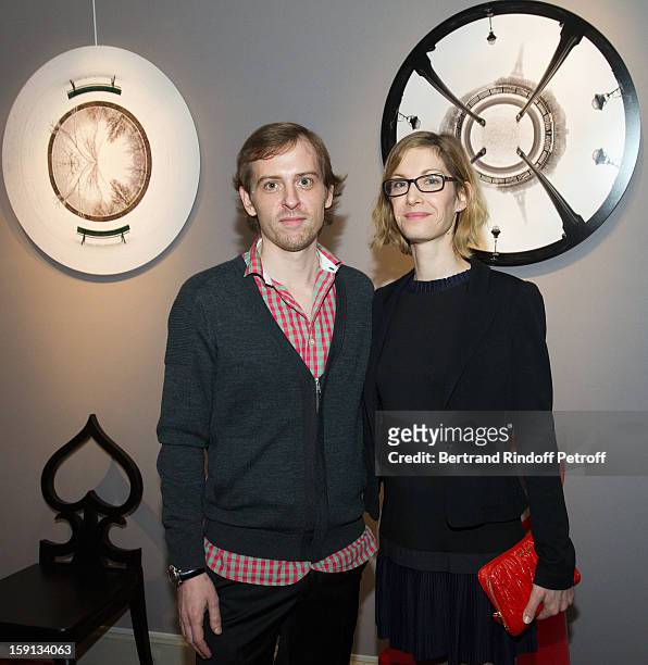 Photographer Charles Maze and his partner pose by two of Maze's photographs during the 'Sorcieres' exhibition preview at Galerie Pierre Passebon on...