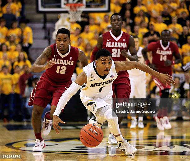 Phil Pressey of the Missouri Tigers controls the ball on a fast break as Trevor Releford; Rodney Cooper, and Moussa Gueye of the Alabama Crimson Tide...