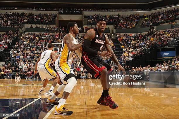 LeBron James of the Miami Heat posts up against Paul George of the Indiana Pacers on January 8, 2013 at Bankers Life Fieldhouse in Indianapolis,...