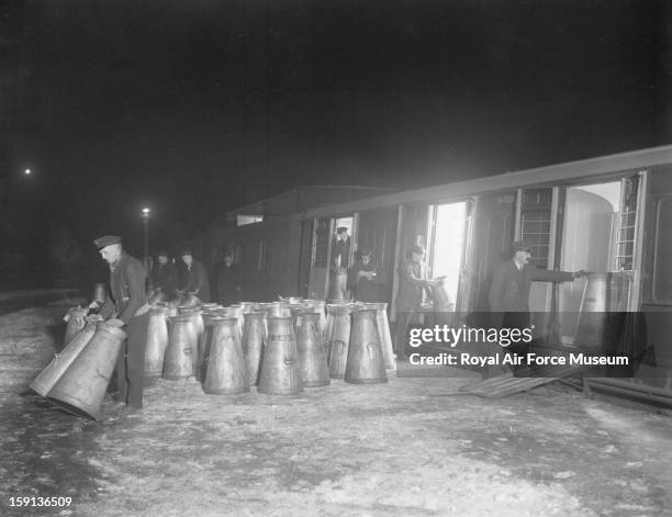 Unloading milk churns from Southern Railway wagons at Clapham Junction station, 1926.