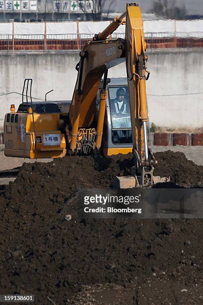 Kato Works Co. Excavator operates on a construction site in Tokyo, Japan, on Tuesday, Jan. 8, 2013. Prime Minister Shinzo Abe aims to compile Japan's...