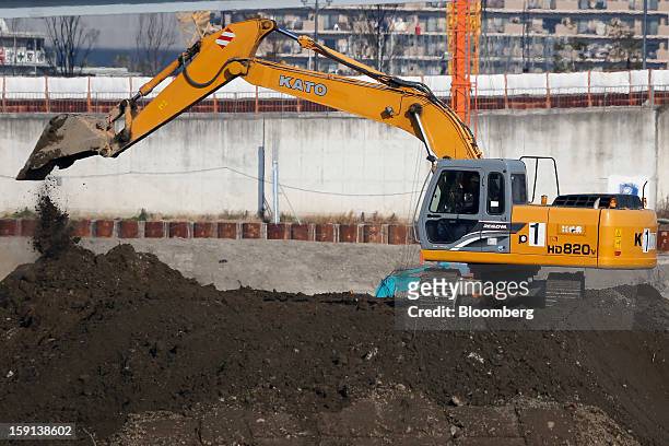 Kato Works Co. Excavator operates on a construction site in Tokyo, Japan, on Tuesday, Jan. 8, 2013. Prime Minister Shinzo Abe aims to compile Japan's...
