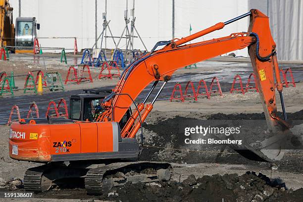 Hitachi Construction Machinery Co. Excavator operates on a construction site in Tokyo, Japan, on Tuesday, Jan. 8, 2013. Prime Minister Shinzo Abe...