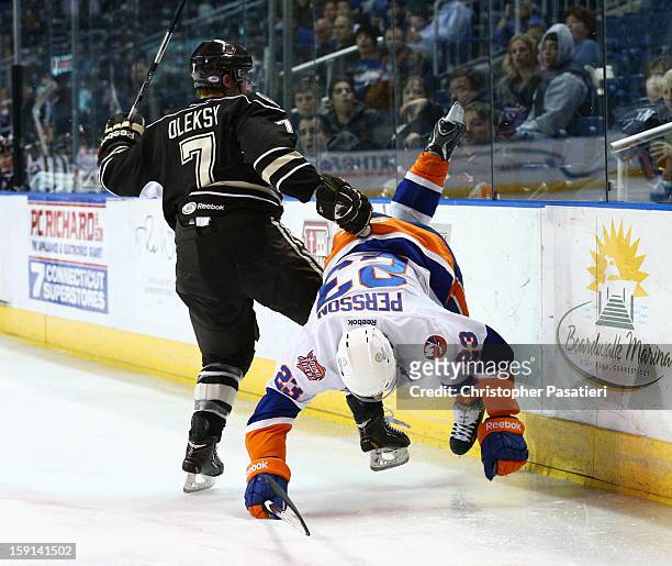 John Persson of the Bridgeport Sound Tigers falls to the ice after being checked by Steve Oleksy of the Hershey Bears during an American Hockey...