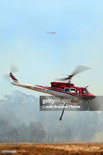 Water-bombing operations take place on a fire at Sandhills on January 9, 2013 in Bungendore, Australia. Temperatures cooled overnight offering relief...