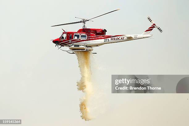 Water-bombing operations take place on a fire at Sandhills on January 9, 2013 in Bungendore, Australia. Temperatures cooled overnight offering relief...