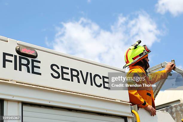 Rural Fire Service member watches water-bombing operations take place on a fire at Sandhills on January 9, 2013 in Bungendore, Australia....