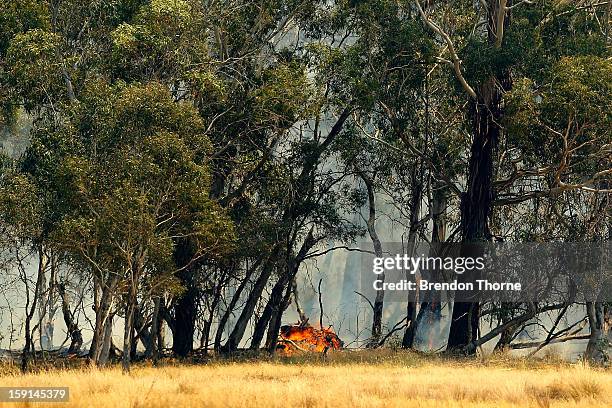 Flames are seen at the Sandhills bushfire on January 9, 2013 in Bungendore, Australia. Temperatures cooled overnight offering relief to fire fighters...