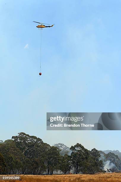 Water-bombing operations take place on a fire at Sandhills on January 9, 2013 in Bungendore, Australia. Temperatures cooled overnight offering relief...
