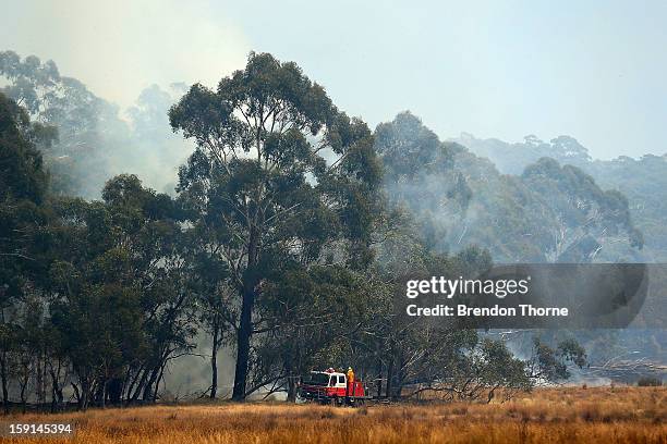 Rural Fire Service members attack the fire at Sandhills from the ground on January 9, 2013 in Bungendore, Australia. Temperatures cooled overnight...