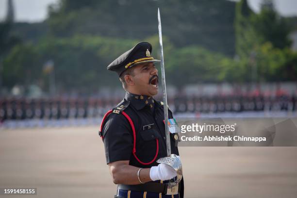 An Indian Army soldier shouts a command as he leads the passing out parade of the first batch of Agniveer soldiers at the ASC Centre & College on...
