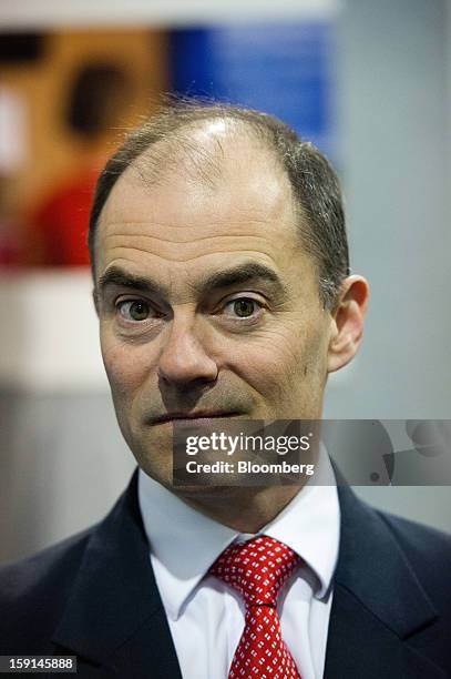 Warren East, chief executive officer of ARM Holdings Plc, stands for a photograph at the 2013 Consumer Electronics Show in Las Vegas, Nevada, U.S.,...