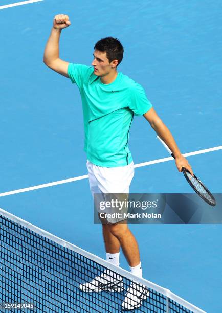 Bernard Tomic of Australia celebrates his win in his second round match over Florian Meyer of Germany during day four of the Sydney International at...