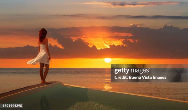 greece. young woman watching sunset - strapless dress stock pictures, royalty-free photos & images