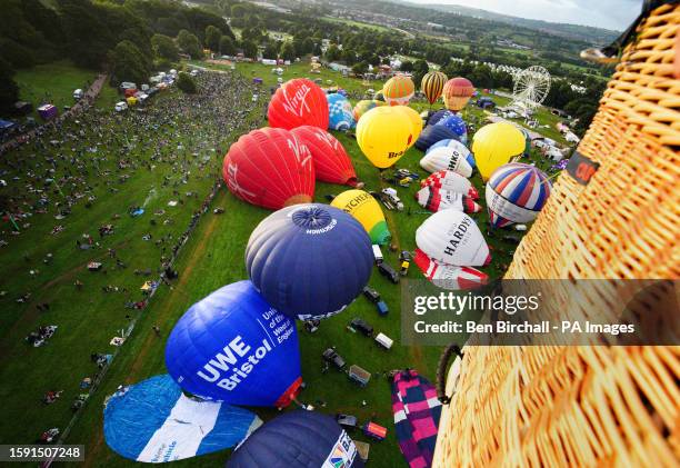 Hot air balloons are inflated during the mass ascent at the Bristol International Balloon Fiesta 2023. Picture date: Friday August 11, 2023.