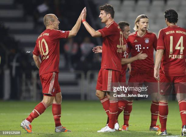 Arjen Robben and Mario Gomez of Bayern Munich celebrate a goal during the friendly game between FC Bayern Munich and FC Schalke 04 at the Al-Sadd...