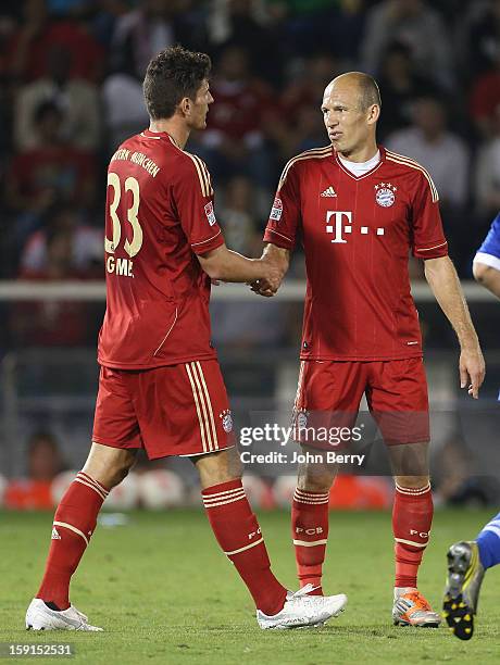 Arjen Robben and Mario Gomez of Bayern Munich celebrate a goal during the friendly game between FC Bayern Munich and FC Schalke 04 at the Al-Sadd...