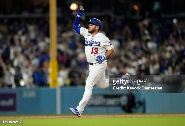 Max Muncy of the Los Angeles Dodgers celebrates as he runs the bases after hitting a one run home run to tie the game against starting pitcher Ty...