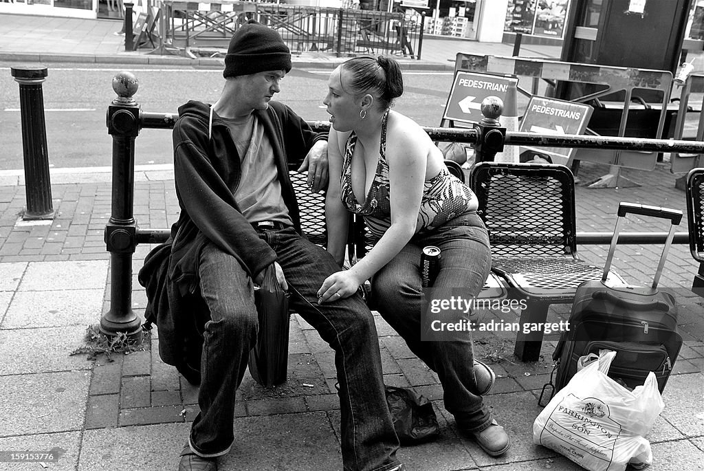 Man and woman on street bench engaged in deep disc