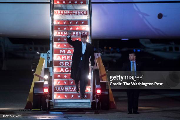 Republican presidential candidate Donald Trump walks off his plane to speak during a campaign event at an Atlantic Aviation hanger in Moon Township,...