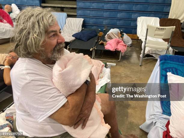 Phil Bailey a dock worker who escaped the deadly wildfire in Lahaina by jumping into the ocean, recovers at an emergency shelter in Wailuku, Hawaii...