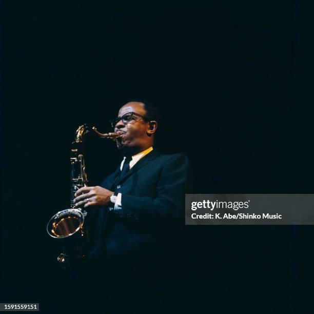 Benny Golson plays the tenor sax into a mic, Shinjuku, Tokyo, Japan, 12 November 1964.