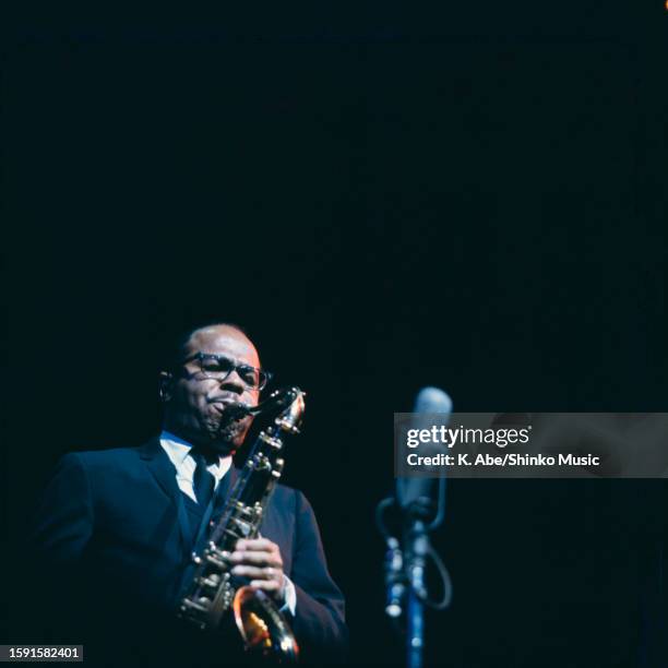 Benny Golson plays the tenor sax into a mic, Shinjuku, Tokyo, Japan, 12 November 1964.