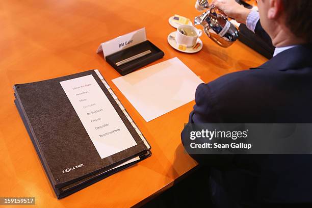 Folder with headers that include: "Topic Of The Day," "Health," "Care," "Prevention" and "Drugs/Addiction" lies next to Health Minister Daniel Bahr...