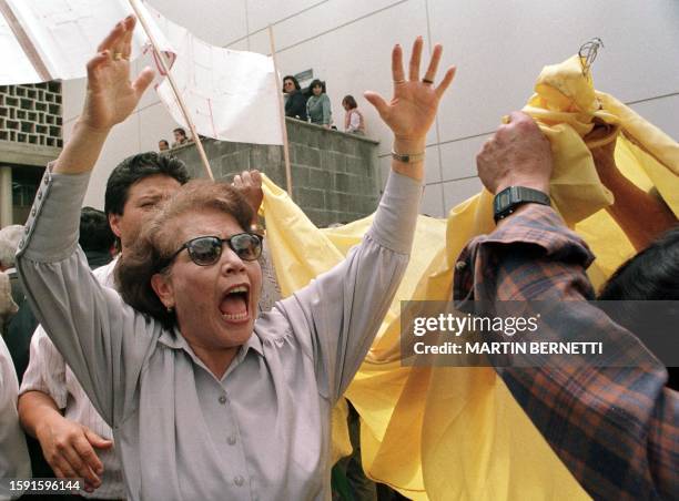 Woman shouts anti-government slogans before the Ecuadoran National Congress 23 March 1999 during a protest rally one day after one the country's top...