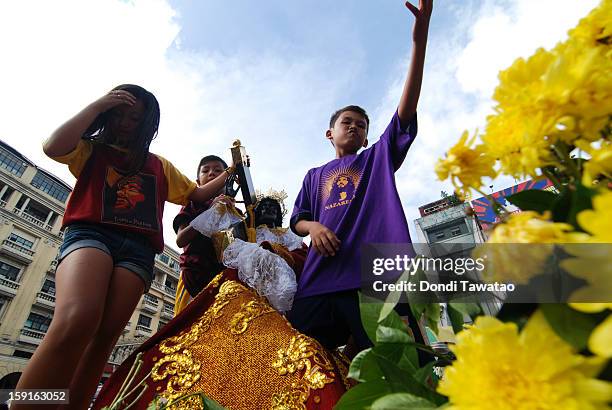 Black Nazarene replicas join the parade of millions of Catholic devotees converging in Quiapo for the 406th feast of The Black Nazarene on January 9,...