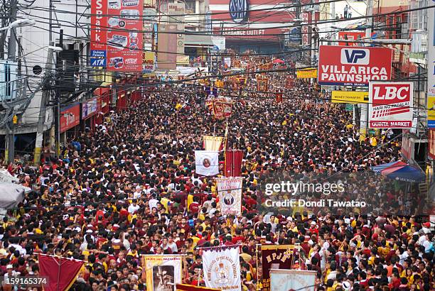 Thousands of Black Nazarene devotees try to get near the carriage carrying the Black Nazarene during the 406th feast of The Black Nazarene on January...