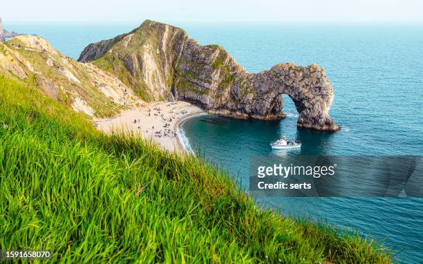 summer bliss at durdle door : iconic limestone arch in lulworth cove, wareham, jurassic coast world heritage, dorset, england, uk - new jersey landscape stock pictures, royalty-free photos & images