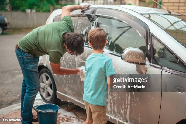 little boy and his father wash car with  at back-yard in summer - man washing basket child stock pictures, royalty-free photos & images