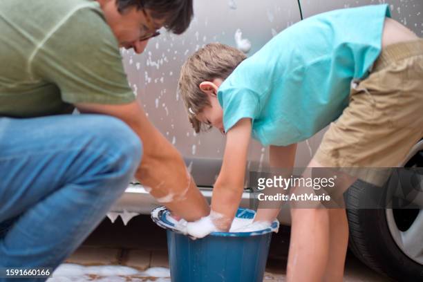 little boy and his father wash car with  at back-yard in summer - man washing basket child stock pictures, royalty-free photos & images