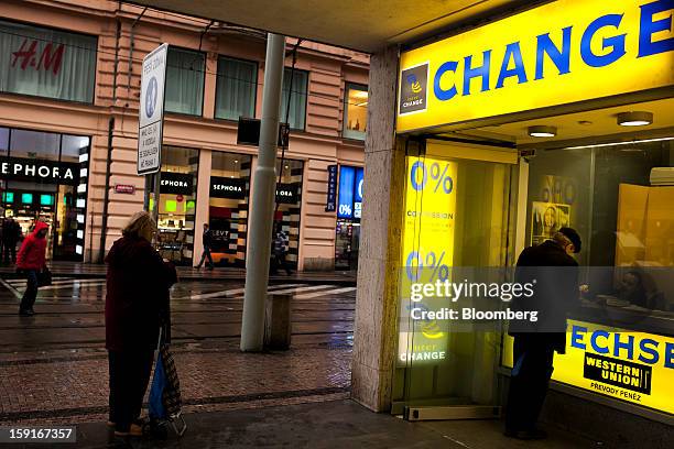 Customer uses a Western Union currency exchange to change money in Prague, Czech Republic, on Tuesday, Jan. 8, 2013. The Czech economy is showing...