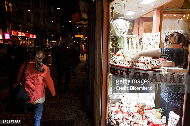 An employee arranges a display of jewellery in the window of a store in the center of Prague, Czech Republic, on Tuesday, Jan. 8, 2013. The Czech...