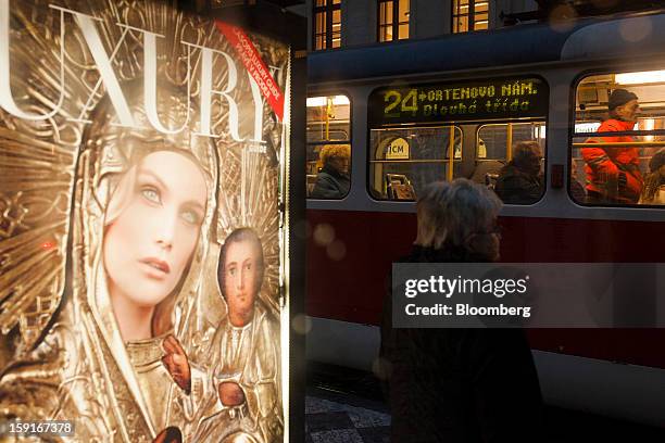 An advertisement for the luxury Prague guide sits illuminated on a bus shelter in the financial district of Prague, Czech Republic, on Tuesday, Jan....