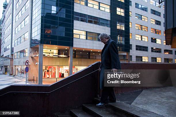 Businessman passes the offices of the Prague Stock Exchange, center, in the financial district of Prague, Czech Republic, on Tuesday, Jan. 8, 2013....