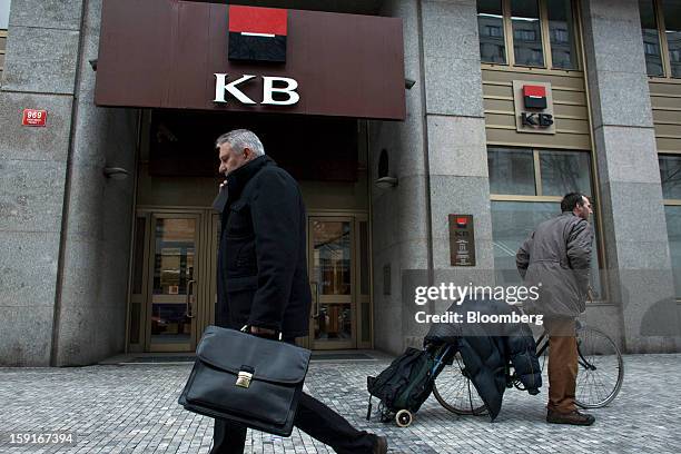 Pedestrians pass the offices of the Komercni Banka AS bank in the financial district of Prague, Czech Republic, on Tuesday, Jan. 8, 2013. The Czech...