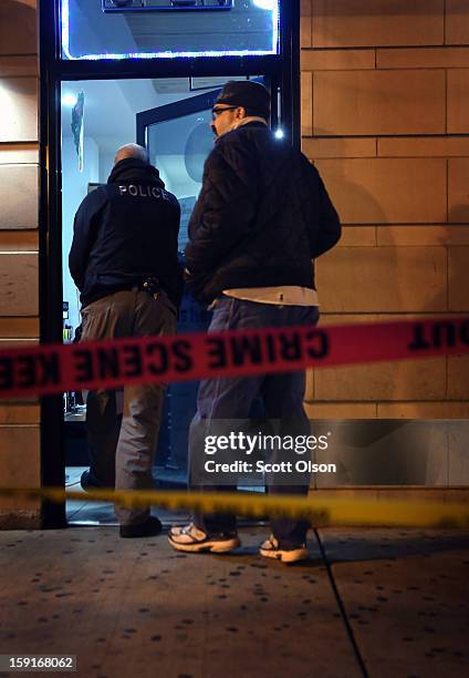 Chicago police investigate the scene where two men were shot in the Old Town neighborhood on January 8, 2013 in Chicago, Illinois. Tyshawn Blanton...