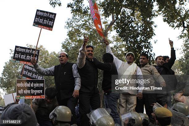 Activists from opposition Bharatiya Janata Party shout anti-Pakistan slogans during a protest march to the Pakistani embassy against the killing of...