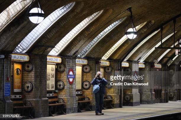 Passenger takes a photograph of a platform at Baker Street Underground Station on January 9, 2013 in London, England. Baker Street Station shares the...