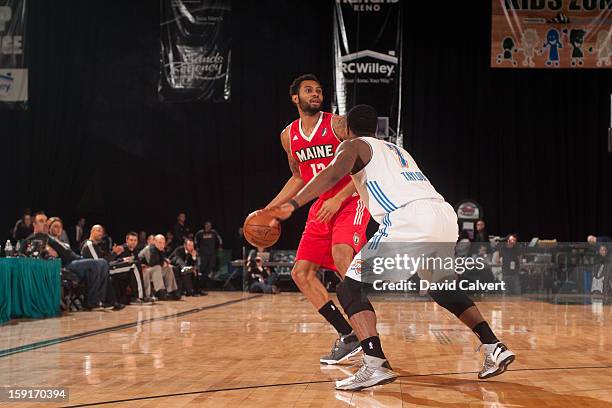 Xavier Silas of the Maine Red Claws dribbles the basketball guarded by Tony Taylor of the Tulsa 66ers during the 2013 NBA D-League Showcase on...