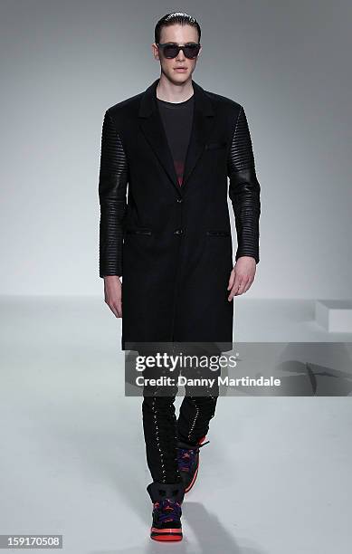 Model walks the catwalk at the Katie Eary show at the London Collections: MEN AW13 at The Hospital Club on January 9, 2013 in London, England.