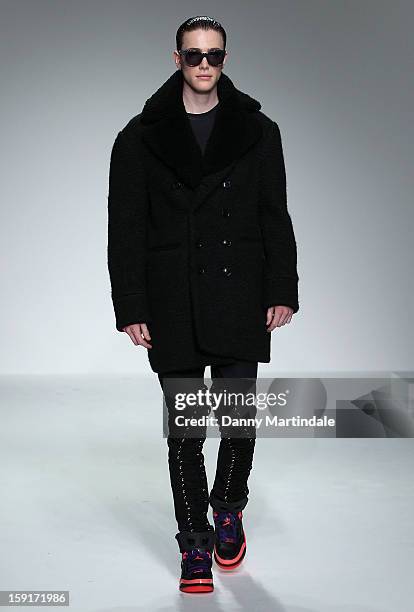 Model walks the catwalk at the Katie Eary show at the London Collections: MEN AW13 at The Hospital Club on January 9, 2013 in London, England.