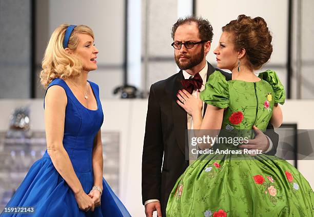 Maria Furtwaengler, Nikolaus Szentmiklosi and Alessija Lause perform during the 'Geruechte...Geruechte...' photo rehearsal at Komoedie am...